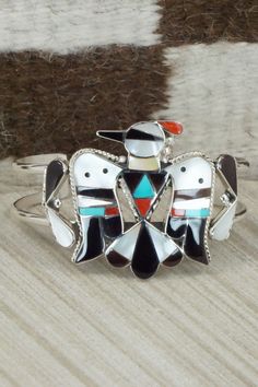 This turquoise, onyx, mother of pearl, coral and sterling silver inlay set was made by Zuni silversmith Bobby Shack. The set is signed B&C Shack, Zuni and Sterling.Necklace: 15"Pendant Length: 2 3/8"Pendant Width: 2 1/4"Earrings:Length: 1 7/8"Width: 3/4"Bracelet:Size: 5" (will fit up to a 6 3/8" wrist)Gap: 1 3/8"Width: 1 5/8"Free shipping on all orders! We ship with USPS and always include tracking. All orders ship within a day of payment.Returns are accepted up to 30 days after you receive your Sterling Silver Jewelry With White Inlay, White Sterling Silver Jewelry With Inlay, Unique Multicolor Mother Of Pearl Jewelry, Southwestern Jewelry With Inlay For Gifts, Southwestern Style Jewelry With Inlay For Gift, Multicolor Mother Of Pearl Jewelry Gift, Multicolor Mother Of Pearl Jewelry For Gifts, Southwestern Style Inlay Jewelry As Gift, Traditional White Jewelry With Inlay