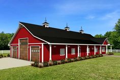 a red barn with white trim and black roof