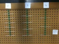 a peg board with pins and numbers on it