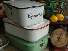 there are three containers stacked on top of each other next to some lemons and an old clock