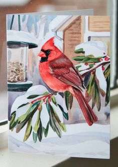 a painting of a cardinal sitting on a branch in front of a snow covered window