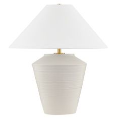 a white lamp with a gold base and a white shade on the top of it