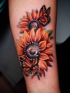 a sunflower with two butterflies on it's arm, and the other one is in