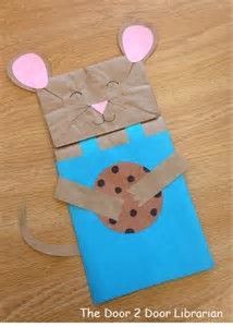 a paper bag shaped like a mouse holding a cookie