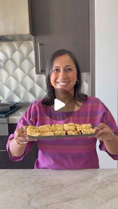 a woman holding a plate with food on it