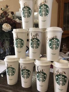 many starbucks cups are stacked on top of each other