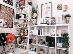 a room filled with lots of white shelves and pictures on the wall next to each other