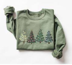 Green Tree Christmas Sweater, Christmas Sweater, Christmas Crewneck, Christmas Tree Sweatshirt,Holiday Sweaters for Women, Winter Sweatshirt We design trendy sweatshirts that you can use in every important day of your life. We produce beautiful and quality designs that can be used in all kinds of activities that you will do with your family or friends. These designs will offer you and your environment a unique complement. We are very excited to bring you our high quality and soft, trendy sweatsh Sweaters For Women Winter, Holiday Sweaters, Faith Clothing, Christmas Tree Shirt, Christmas Crewneck, Holiday Christmas Tree, Sweater Christmas, Green Christmas Tree, Green Tree