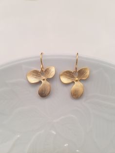 matte finish 16K gold or white gold plated over brass orchid flowers, done with hand brush technique earrings flower measures 15x15mm matching necklaces; Listing: https://www.etsy.com/listing/62788082/triple-orchid-flowers-necklace-16k Listing: https://www.etsy.com/listing/71522563/matte-yellow-gold-two-triple-orchid Listing: https://www.etsy.com/listing/169054989/ready-to-ship-bridesmaids-gift-wedding Matching bracelet: Listing: https://www.etsy.com/listing/62895035/orchid-flowers-bracelet than Gold Petal Earrings For Gift, Gold Nickel-free Flower Earrings As Gift For Her, Gold Petal Flower Earrings For Gifts, Handmade Gold Petal-shaped Jewelry, Orchid Flowers, Earrings Flower, Matching Bracelet, Orchid Flower, Wedding Matches