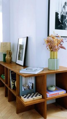 a wooden table topped with books and flowers