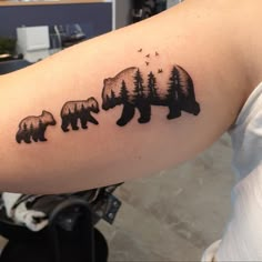 a woman's arm with three bears and birds on it, in the shape of trees