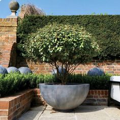 a large planter sitting in the middle of a garden