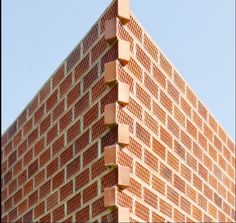 a very tall brick building sitting in the middle of a street