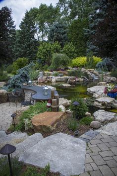 a small pond surrounded by rocks and trees