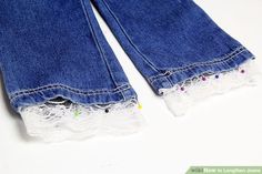 two pairs of blue jeans with white laces on the bottom and one pair is torn off