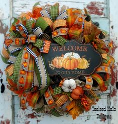 a welcome to our home wreath on a door