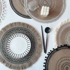 plates and utensils are arranged on a white tablecloth with black trimmings