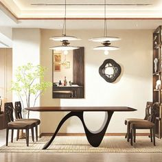 a dining room table with chairs around it and a vase on the wall next to it