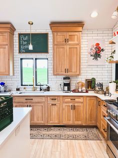 a kitchen with wooden cabinets and white counter tops, along with green oven hoods