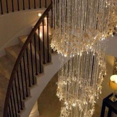 a chandelier hanging from the side of a staircase