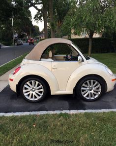 a small white car parked in a parking lot