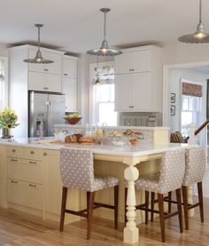 two pictures of a kitchen with white cabinets and counter tops, an island in the middle