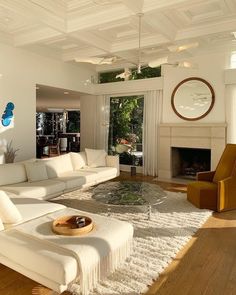 a living room filled with furniture and a fire place in the middle of a room