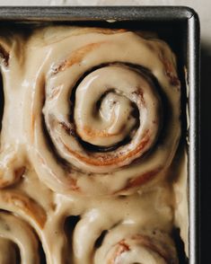 cinnamon rolls in a pan with icing drizzled on top