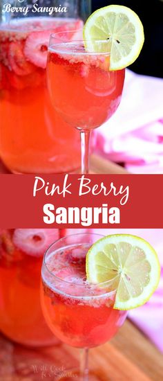 two glasses filled with pink berry sangria on top of a wooden table