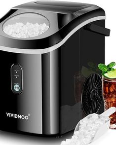 a black and silver ice maker next to a glass filled with minty sodas