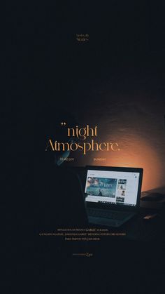 a laptop computer sitting on top of a desk in front of a dark background with the words night atmosphere