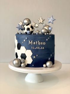 a birthday cake with soccer balls and stars on it