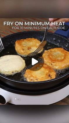 the frying pan is filled with fried food and has a fork in it to stir them