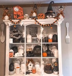 an old china cabinet decorated with halloween decorations