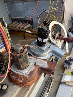 an old machine is being worked on with wires and other equipment in the foreground