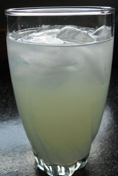 a glass filled with ice sitting on top of a table