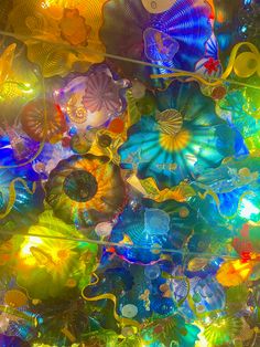 the ceiling is covered in many colorful glass objects