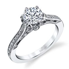 a white gold engagement ring with an intricate design