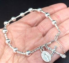 ALL ITEMS ARE HANDCRAFTED IN THE USA. PLEASE REVIEW MY CURRENT SHIPPING POLICIES. WOW WOW! This is so so much like sterling silver without the tarnish and cost This is a simple elegant bright silver hematite gemstone rosary bracelet for that special Catholic woman! A modern take on a very traditional rosary bracelet! Hematite is generally a black color, but they have recently been doing this gemstone in many colors and this is brand new and emulates silver so much I am in awe!! I wear this every Silver Rosary, Catholic Women, Rosary Bracelet, Catholic Gifts, Simple Elegant, Bracelet Silver, Shiny Silver, Rosary, Silver Bracelets