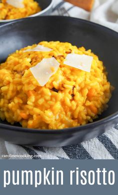 pumpkin risotto with parmesan cheese in a black bowl on a striped towel