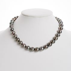 This one-of-a-kind necklace is composed of gorgeous round Tahitian pearls measuring 10.0-12.5 mm in size and is approximately 18 inches in length. The pearls feature a medium silver body color with peacock overtones. Your Tahitian strand will arrive double knotted on color-matching silk. The knotting protects your pearls from rubbing against each other, and if your necklace ever breaks, you won't lose a single pearl. The necklace is finished with a solid, 14 karat clasp with a safety catch for a Classic Tahitian Pearl Necklace With Round Beads, Luxury Single Strand Tahitian Pearl Necklace, Classic Tahitian Pearl Round Bead Necklaces, Classic Tahitian Pearl Round Bead Necklace, Formal Single Strand Tahitian Pearl Necklace, Luxury Tahitian Pearl Single Strand Necklace, Classic Tahitian Pearl Beaded Necklace, Tahitian Pearl Necklace With Single Strand Of Round Beads, Luxury Tahitian Pearl Necklace With Round Beads