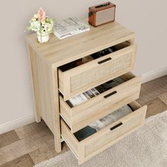 a wooden cabinet with three drawers on the bottom and one drawer open to reveal magazines