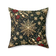 a black pillow with gold and red flowers on it