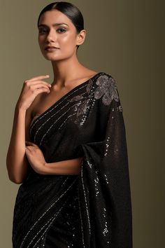 Black sequin embellished sheeting saree, elevated with gloss finish black sequins and contemporary flowers in swarovski crystals on the border and pallu.
Component: 1
Pattern: Embellished
Type Of Work: Sequins,Beads,Crystals
Fabric: Saree: Georgette
Color: Black
Other Details: 
Note: Blouse worn by the model is not for sale
Occasion: Cocktail,Reception - Aza Fashions Sequins Saree, Saree Georgette, White Ruffle Dress, Set Saree, Saree Gown, A Line Kurta, Embroidered Saree, Black Saree, Cocktail Reception