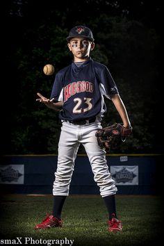 a young baseball player holding a ball in his right hand and wearing a catchers mitt