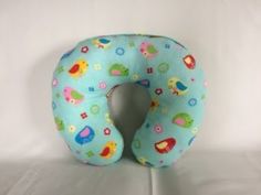 an inflatable travel pillow with birds and flowers on it sits on a white surface