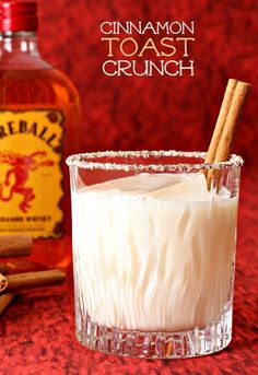 cinnamon toast crunch cocktail in a glass with two cinnamon sticks