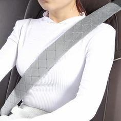 a woman sitting in the back seat of a car with her head resting on an arm rest