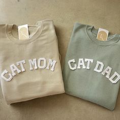 This couple cat mom and cat dad crewneck sweatshirt are the perfect gift to yourselves and to your loved ones! - They need to be purchased individually (it's not sold as a set) - Sweatshirt material is super soft and comfy! ♡ - All our sweatshirts run a UNISEX fit. (Both for men and women). They are naturally oversized, so we normally recommend your true size. But if you like a more baggy look, we recommend sizing up. - These letters are iron-on patched and is heat pressed, not embroidered. - Pl Cat Mom Sweatshirt, Cat Dad Shirt, Cat Dad Gifts, Cat Mom Shirt, Papa Shirts, Cat Mom Shirts, Cat Mom Gifts, Cat Parenting, Mama Shirts