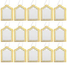 twelve gold and white tags hanging from strings on a white background with clippings